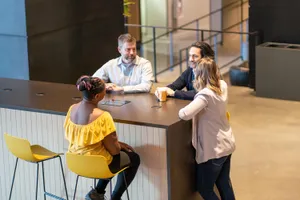 The Ally Co. brand photo containing coffee,table,talking,conversation